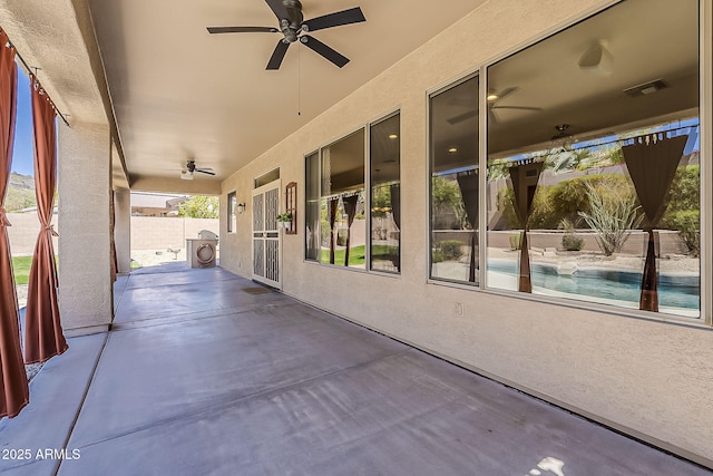 view of patio / terrace featuring a ceiling fan, fence, and visible vents