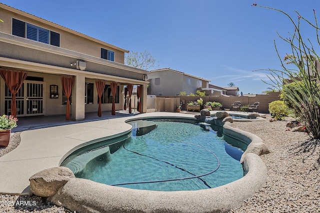 view of swimming pool with a fenced in pool, a fenced backyard, and a patio area