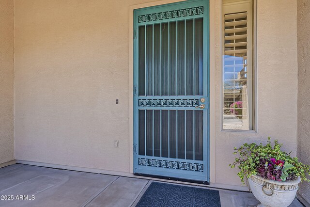 property entrance with stucco siding