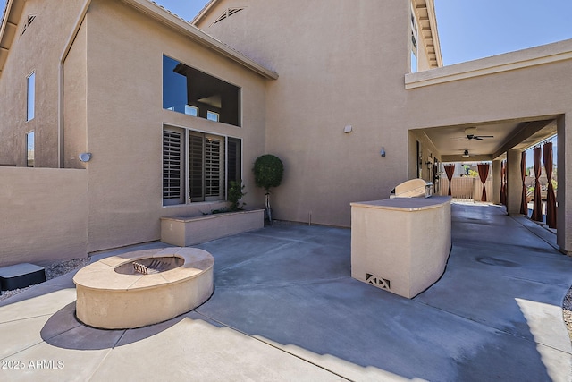 view of patio featuring a fire pit and fence