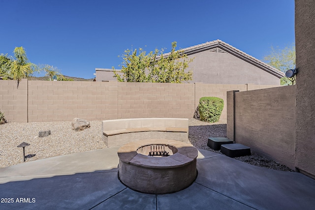 view of patio / terrace featuring an outdoor fire pit and a fenced backyard