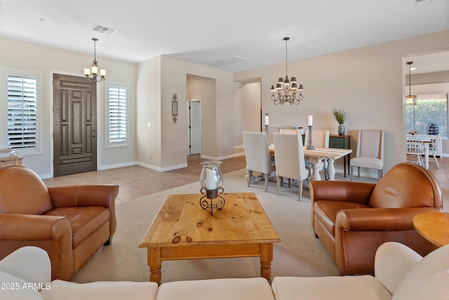 living room with light tile patterned flooring and a notable chandelier