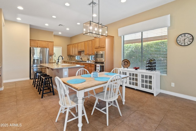 dining space with sink and light tile patterned flooring