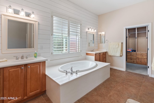 bathroom featuring vanity, tile patterned flooring, and a washtub