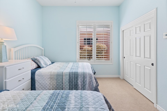 bedroom with a closet and light carpet