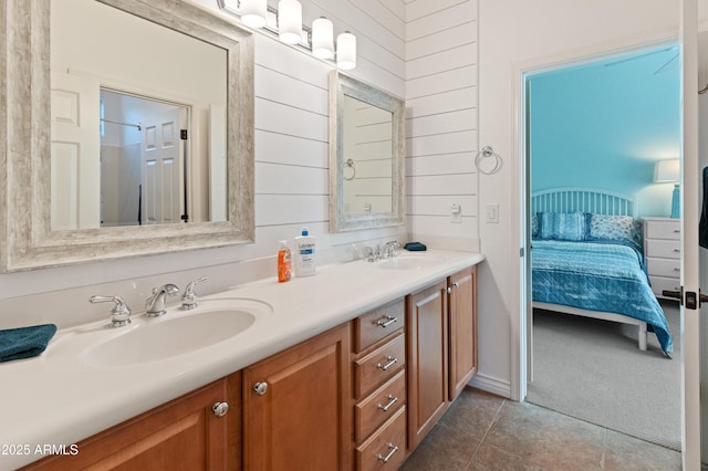 bathroom with tile patterned floors, vanity, and wood walls