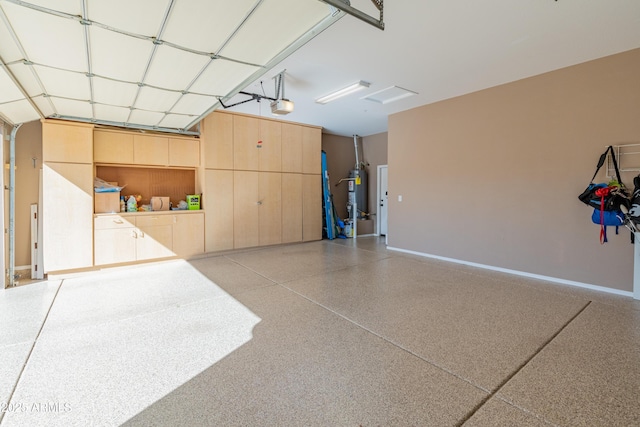 garage featuring a garage door opener and water heater