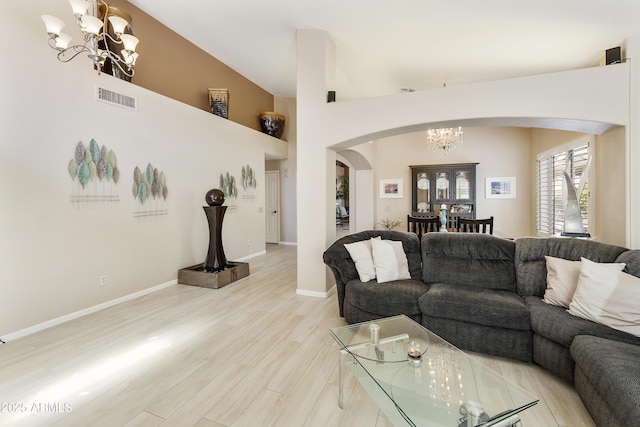 25042 S Hollygreen Dr, Sun Lakes, AZ 85248 - living room with an inviting chandelier, visible vents, wood finished floors, baseboards, and arched walkways