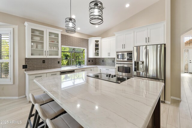 25042 S Hollygreen Dr, Sun Lakes, AZ 85248 - kitchen with appliances with stainless steel finishes, tasteful backsplash, a sink, white cabinets, and lofted ceiling