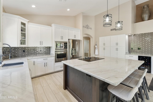 25042 S Hollygreen Dr, Sun Lakes, AZ 85248 - kitchen featuring decorative backsplash, appliances with stainless steel finishes, a sink, beverage cooler, and lofted ceiling