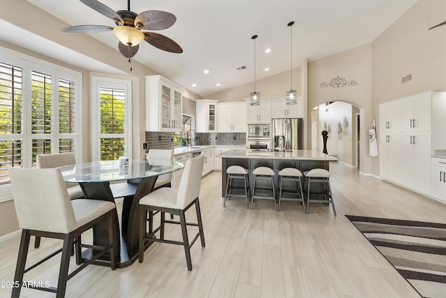 25042 S Hollygreen Dr, Sun Lakes, AZ 85248 - dining space with visible vents, ceiling fan, recessed lighting, arched walkways, and vaulted ceiling