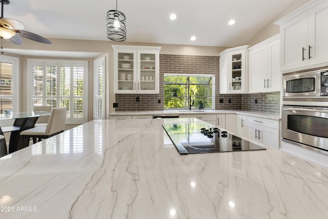 25042 S Hollygreen Dr, Sun Lakes, AZ 85248 - kitchen featuring decorative backsplash, recessed lighting, white cabinets, a sink, and stainless steel appliances