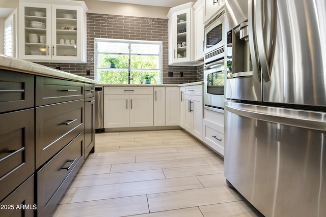 25042 S Hollygreen Dr, Sun Lakes, AZ 85248 - kitchen featuring white cabinets, stainless steel appliances, decorative backsplash, wood tiled floor, and glass insert cabinets
