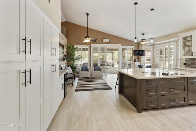 25042 S Hollygreen Dr, Sun Lakes, AZ 85248 - kitchen featuring glass insert cabinets, open floor plan, black electric stovetop, white cabinets, and a ceiling fan