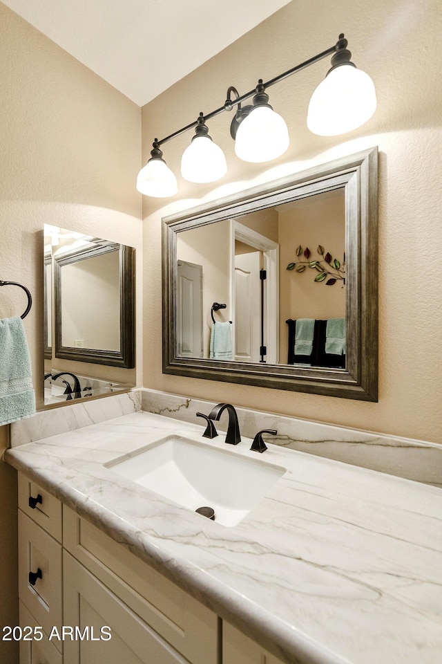 25042 S Hollygreen Dr, Sun Lakes, AZ 85248 - bathroom featuring vanity and a textured wall