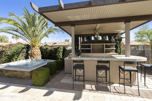 25042 S Hollygreen Dr, Sun Lakes, AZ 85248 - view of patio featuring fence, a gazebo, outdoor wet bar, ceiling fan, and an outdoor hot tub