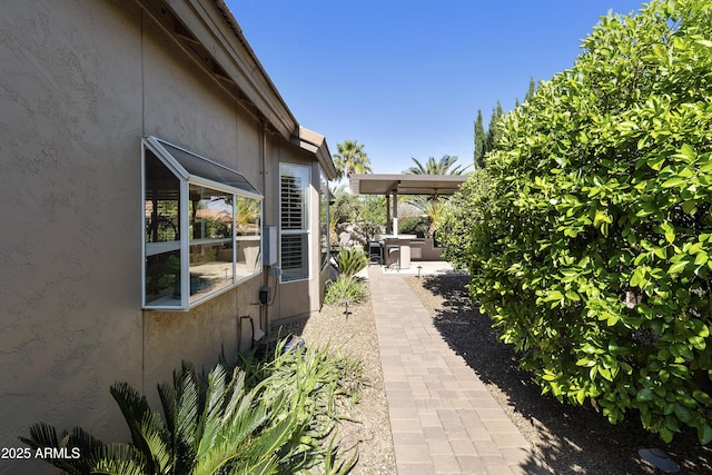 25042 S Hollygreen Dr, Sun Lakes, AZ 85248 - view of property exterior with a patio area and stucco siding
