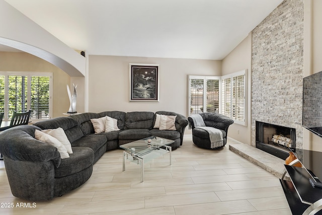 25042 S Hollygreen Dr, Sun Lakes, AZ 85248 - living area featuring arched walkways, vaulted ceiling, and a fireplace