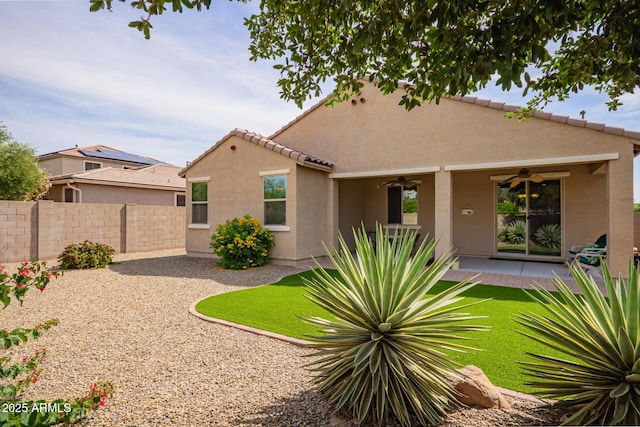 back of property featuring a ceiling fan, fence, stucco siding, and a patio