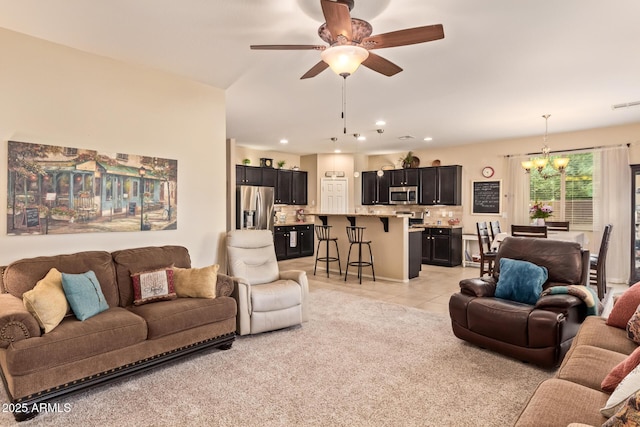 living area with a chandelier, ceiling fan, light tile patterned floors, and recessed lighting