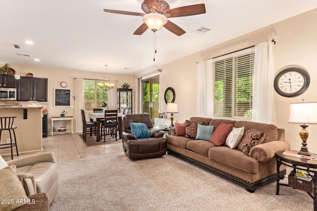 living area featuring a chandelier, a ceiling fan, light tile patterned flooring, and recessed lighting