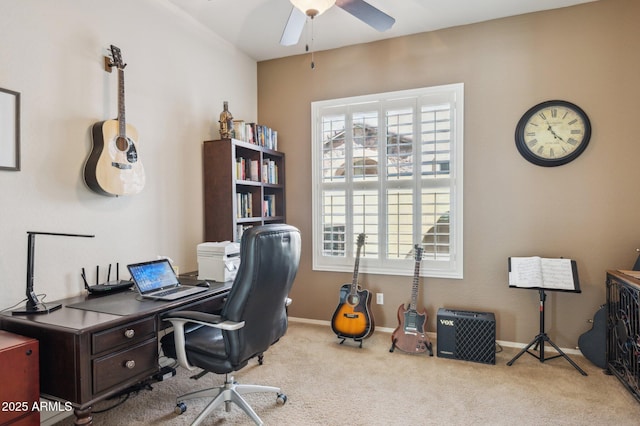 carpeted office featuring baseboards and a ceiling fan