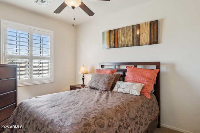 bedroom featuring carpet floors, a ceiling fan, visible vents, and baseboards