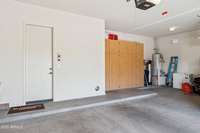 garage with a garage door opener and water heater