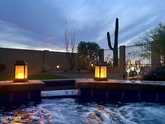 view of swimming pool featuring fence