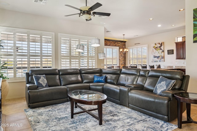 living room featuring ceiling fan with notable chandelier, tile patterned flooring, visible vents, and recessed lighting