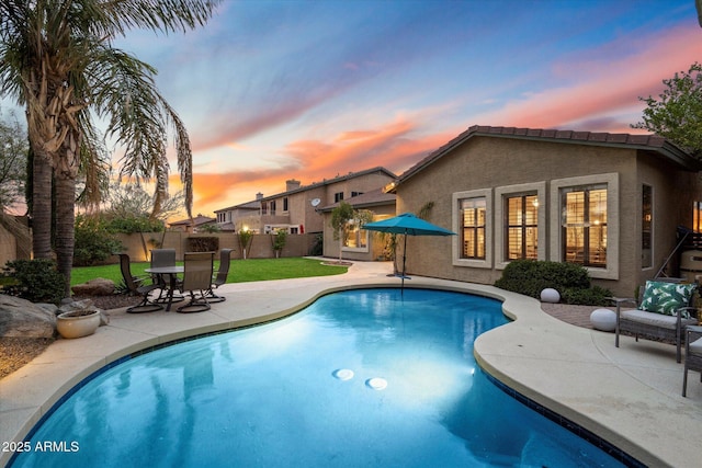 view of pool featuring a patio area, fence, a fenced in pool, and a yard