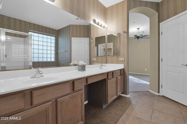 bathroom featuring ceiling fan, vanity, a shower with shower door, and tile patterned flooring