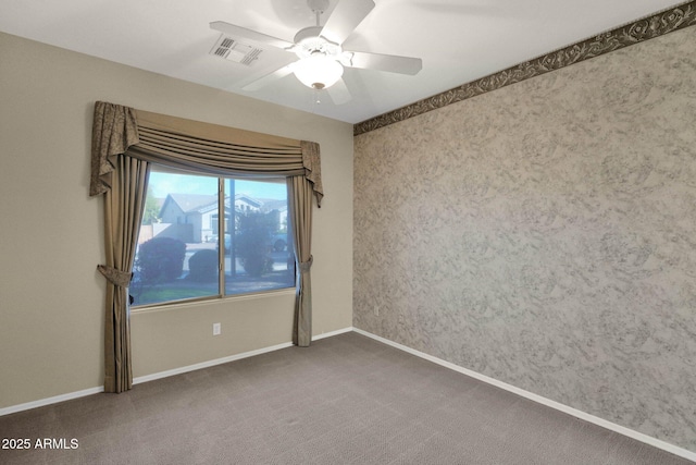 carpeted empty room featuring ceiling fan