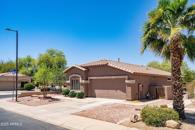 4976 S Sugarberry Ln, Gilbert, AZ 85298 - mediterranean / spanish-style home with stucco siding, a tiled roof, a garage, and concrete driveway