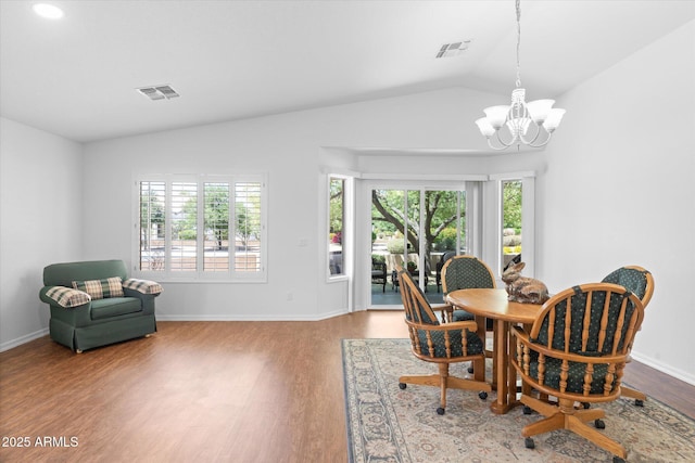 4976 S Sugarberry Ln, Gilbert, AZ 85298 - dining area featuring wood finished floors, a chandelier, healthy amount of natural light, vaulted ceiling, and baseboards