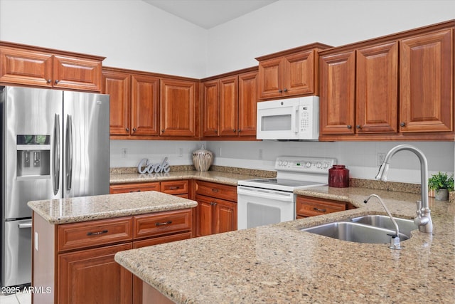 4976 S Sugarberry Ln, Gilbert, AZ 85298 - kitchen with white appliances, a sink, light stone countertops, and brown cabinets