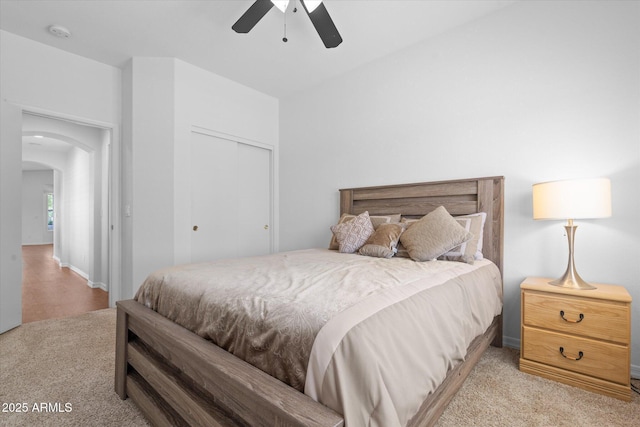 4976 S Sugarberry Ln, Gilbert, AZ 85298 - bedroom featuring light carpet, arched walkways, a closet, and ceiling fan