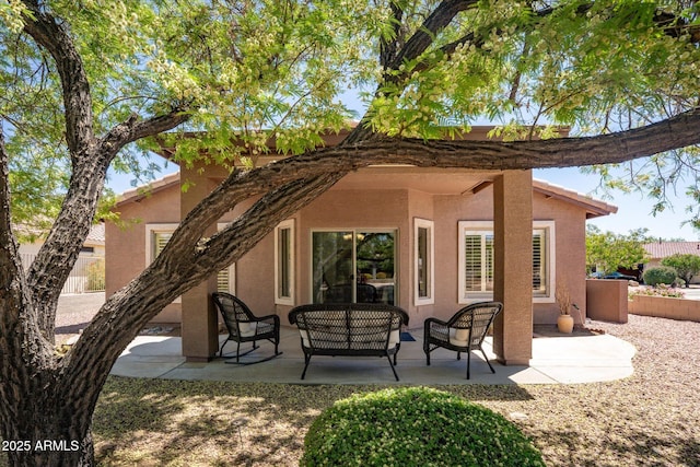 4976 S Sugarberry Ln, Gilbert, AZ 85298 - rear view of house featuring stucco siding, outdoor lounge area, a patio area, and fence