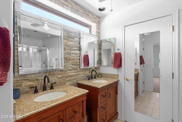 4976 S Sugarberry Ln, Gilbert, AZ 85298 - bathroom featuring a stall shower, tile patterned flooring, backsplash, a ceiling fan, and two vanities