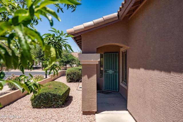 4976 S Sugarberry Ln, Gilbert, AZ 85298 - view of exterior entry featuring stucco siding and a tile roof
