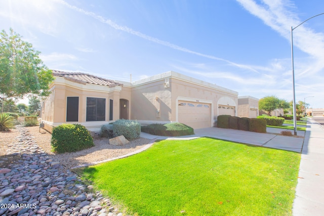 view of front of home with a front yard and a garage