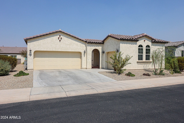 mediterranean / spanish house with a garage