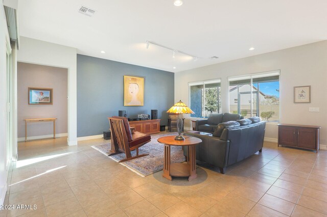 living room featuring light tile patterned floors and track lighting