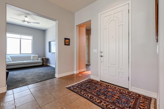 tiled entryway with ceiling fan