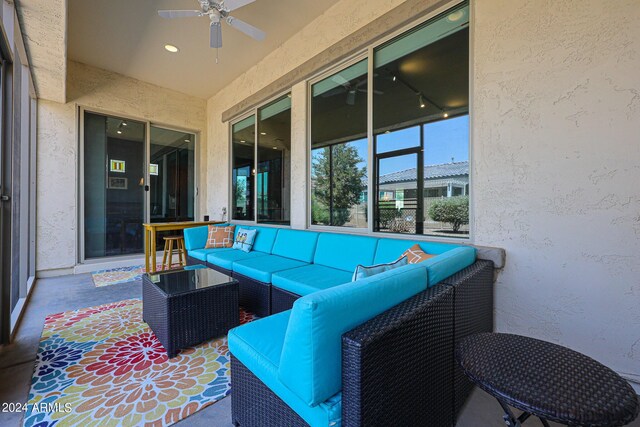 sunroom featuring ceiling fan