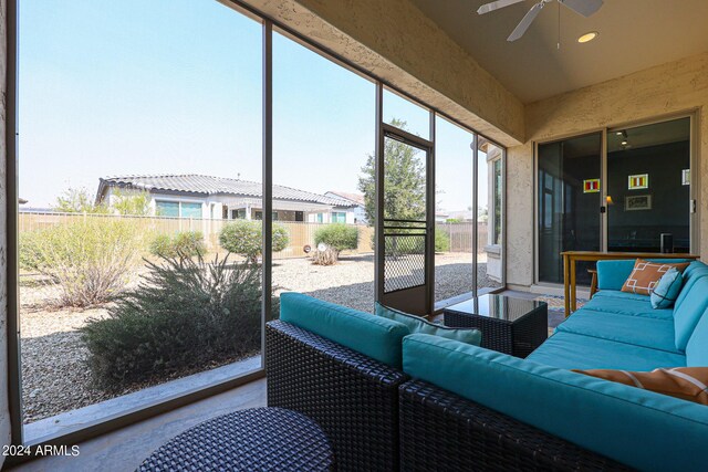 sunroom featuring ceiling fan