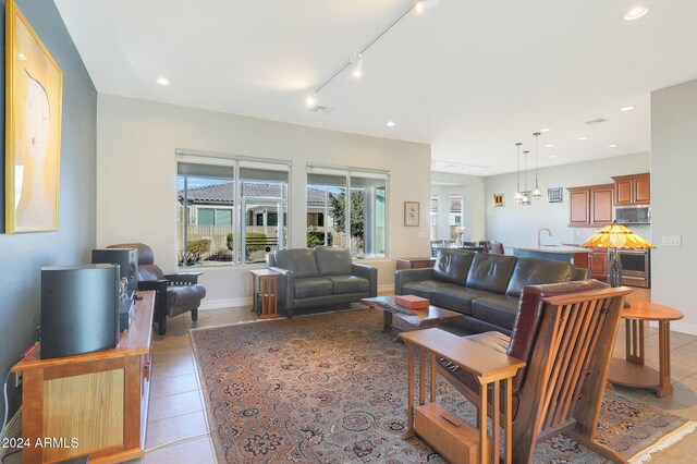 living room featuring light tile patterned floors and track lighting