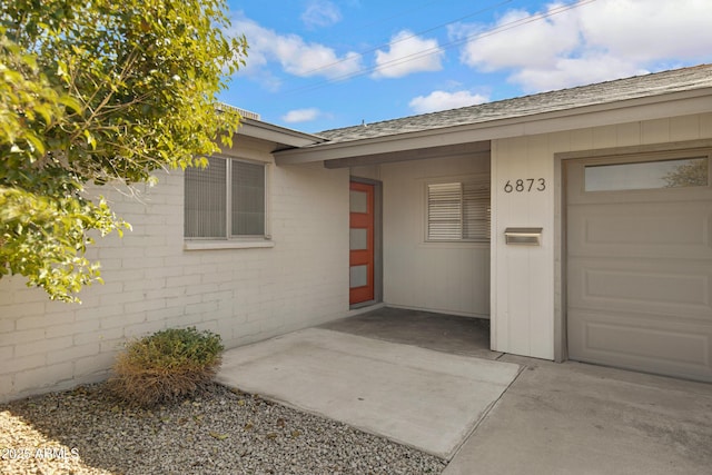 view of exterior entry with a garage