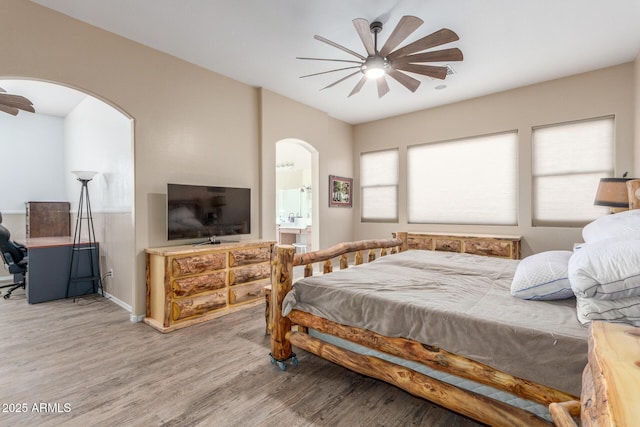 bedroom featuring connected bathroom, ceiling fan, and hardwood / wood-style floors