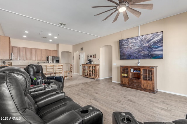 living room featuring ceiling fan and light wood-type flooring